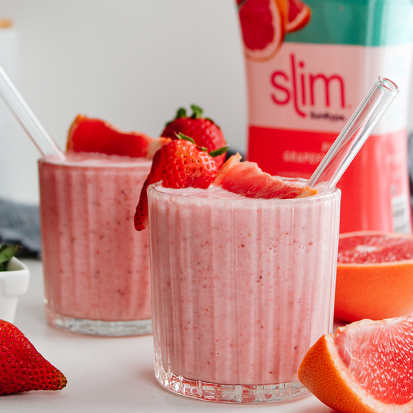 Citrusy strawberry & grapefruit smoothie in a glass with straw