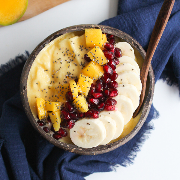 Bright mango smoothie bowl with fresh toppings