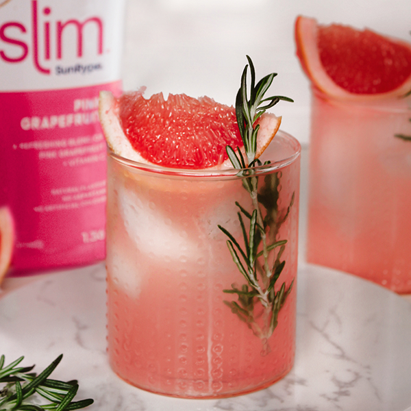 Chic greyhound cocktail with grapefruit wedge & rosemary